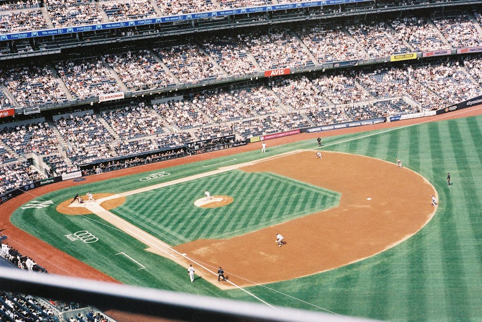 A baseball diamond with bases and a pitcher's mound on a sunny day.