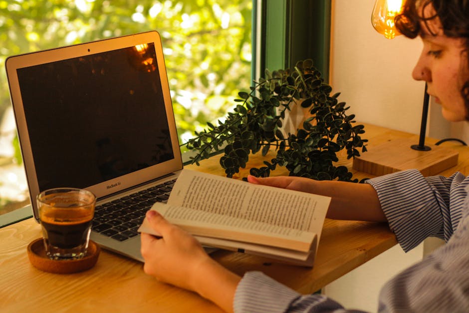 A cozy workspace with a laptop, plants, and a cup of coffee