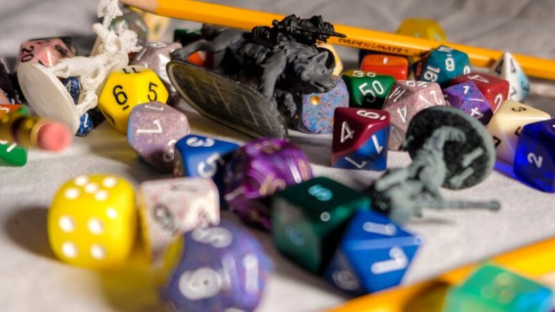 Colorful game elements on a classroom desk with natural light