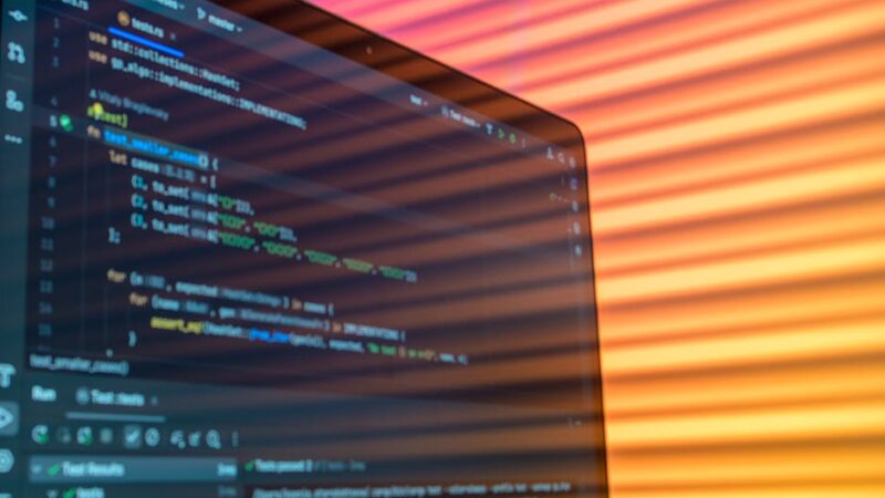A modern workspace with a laptop and digital graphs in soft light.