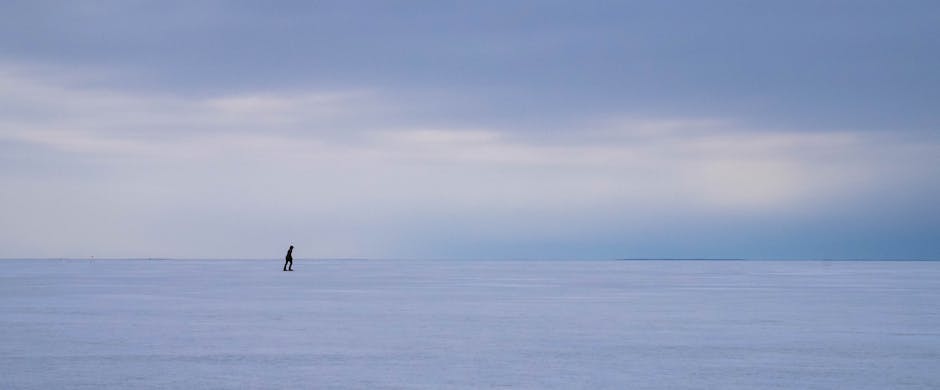 A serene frozen landscape with ice crystals and distant mountains.