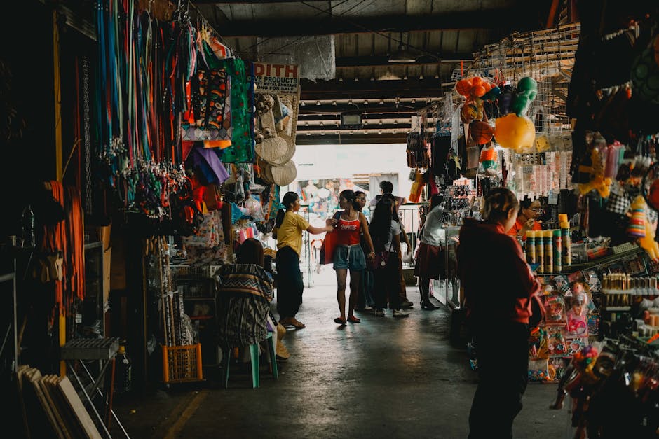 A lively market with colorful stalls and shoppers interacting.