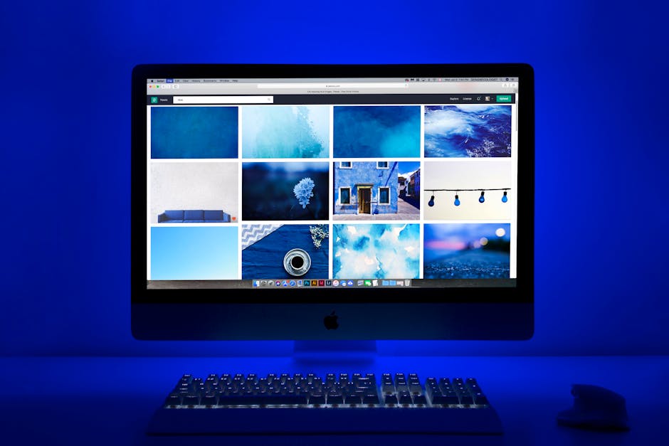 A modern workspace with a computer and creative tools in soft lighting.