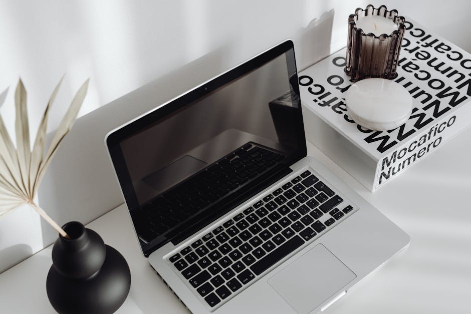 A stylish modern workspace with a laptop and natural light.