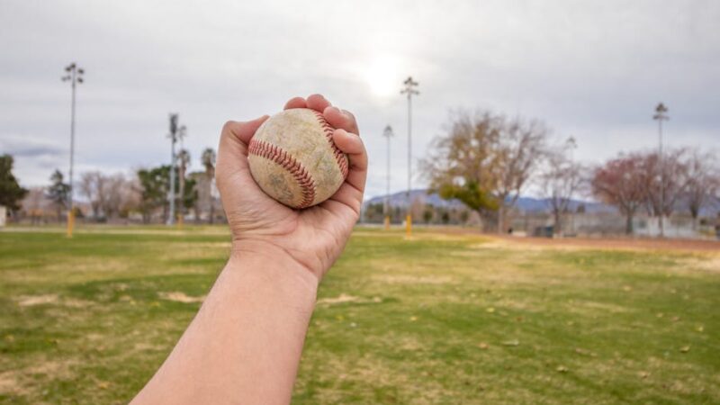 A sunny baseball field with a diamond and green grass
