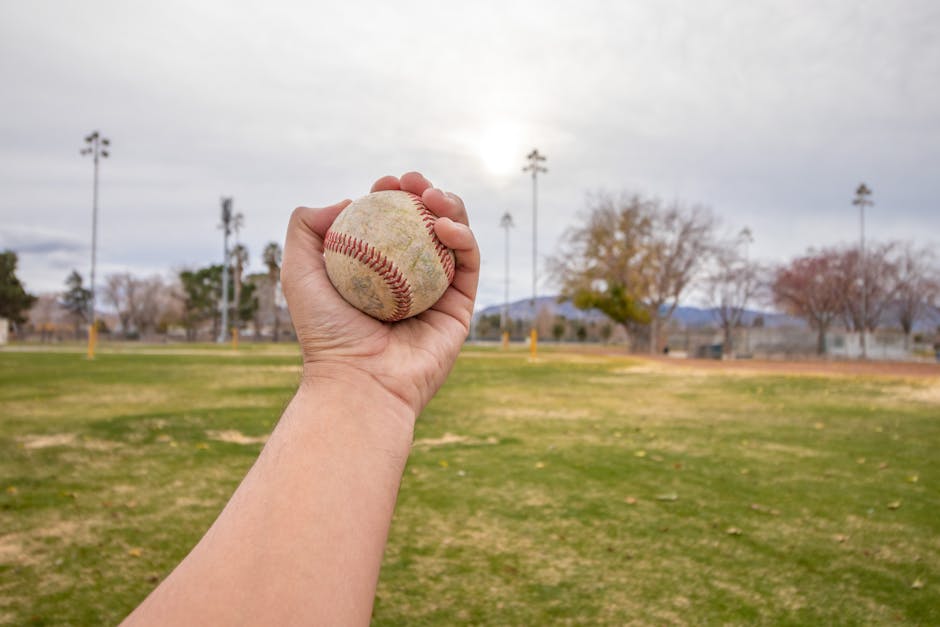 A sunny baseball field with a diamond and green grass