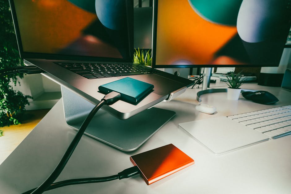 A modern workspace with a computer, GPU, and SSD drive setup.