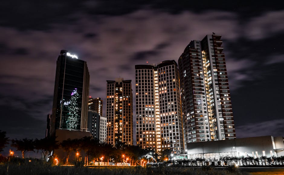 A vibrant city skyline at dusk with glowing buildings and soft lights.