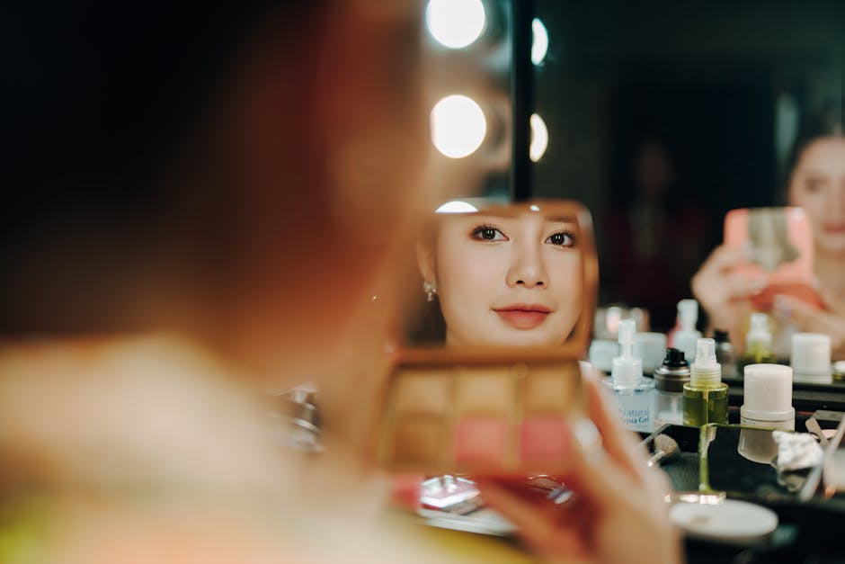 A beautifully arranged vanity with a mirror and beauty products.