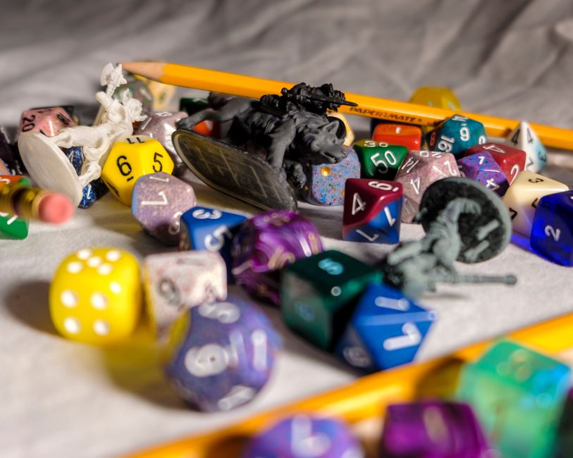 A colorful tabletop with gaming elements like controllers and dice.