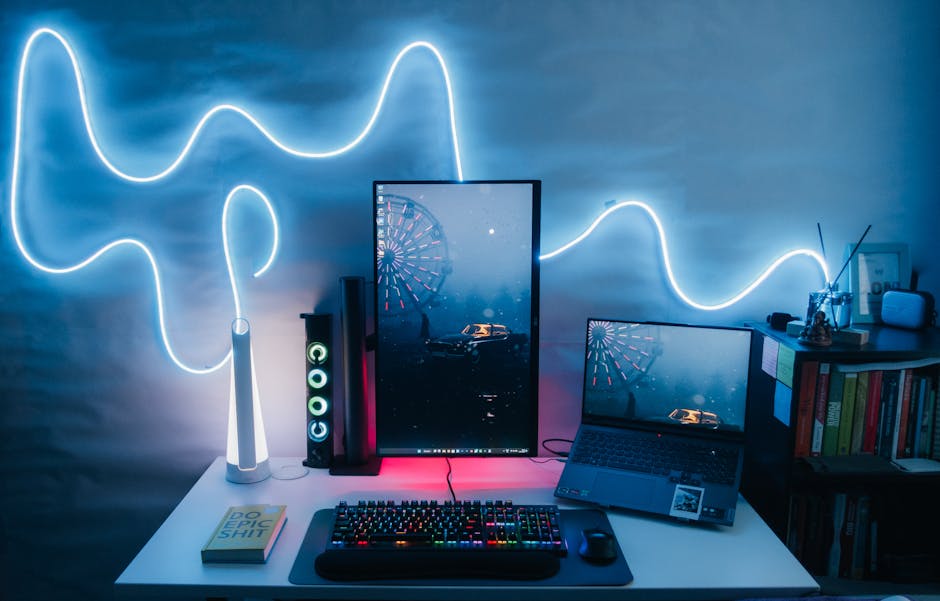 A digital workspace with a computer and abstract digital art displayed.