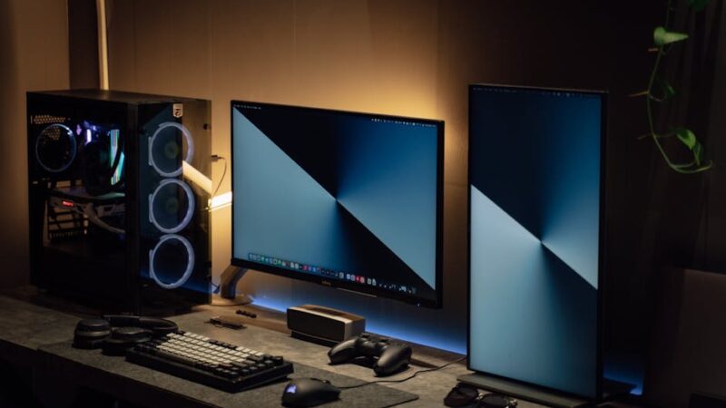 A modern workspace with a high-tech computer and ambient lighting.