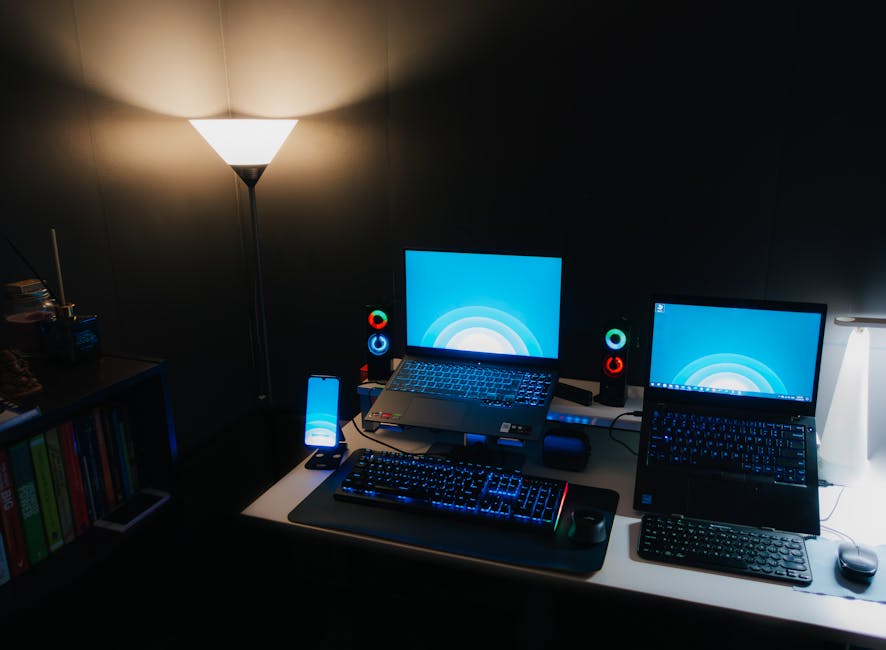 A modern workspace with a computer and creative tools illuminated by soft light.