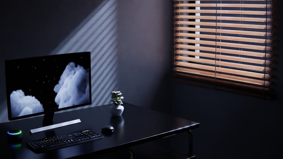 A minimalist workspace with soft lighting and a blurred computer screen.