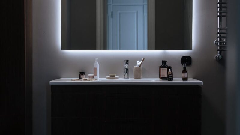 A modern vanity setup with soft lighting and beauty products.