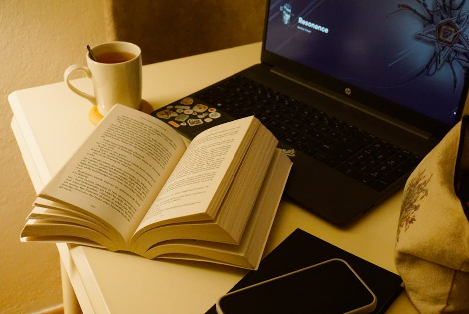 A cozy study setup with a notebook and a cup of tea on a desk