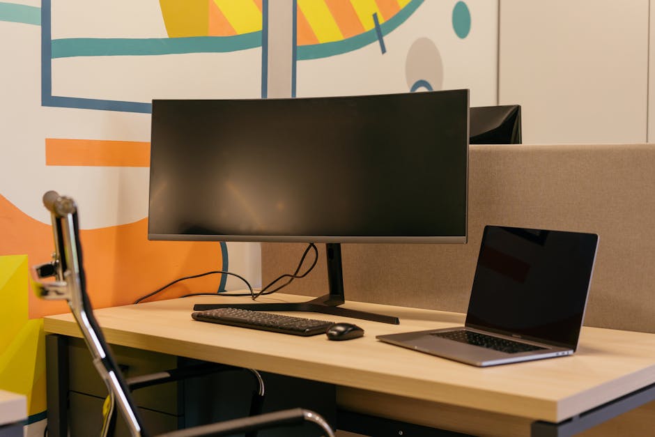 A modern workspace with a computer and abstract shapes around it.