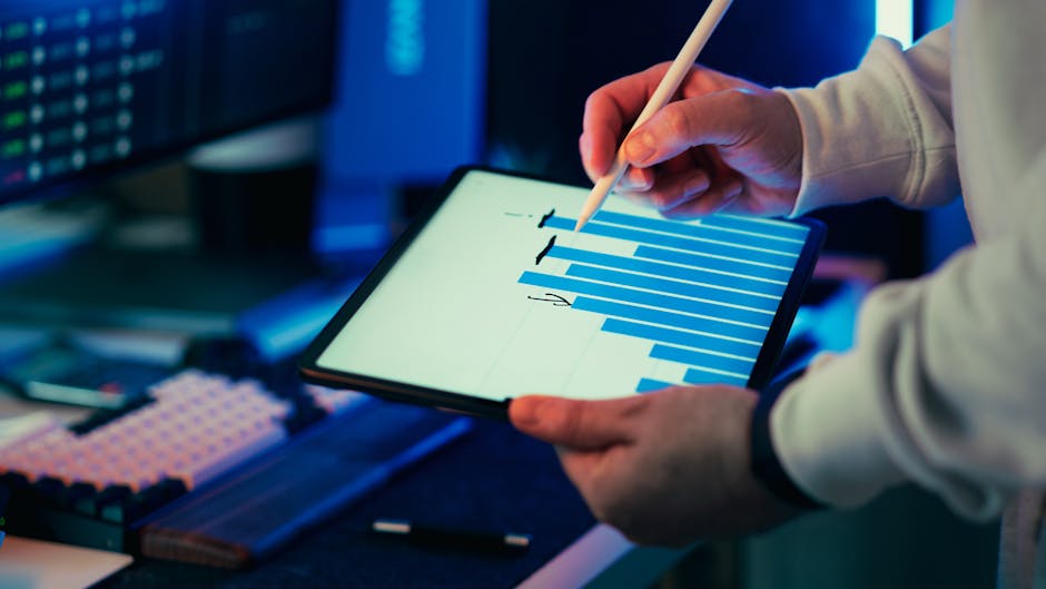 A contemporary workspace with devices and data visuals in soft lighting.